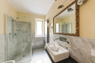 a bathroom with a shower and a sink and a mirror at Hotel Residence Pernhof in Termeno