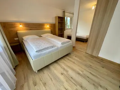 a bedroom with a large bed in a room at Transit Rooms - Your Stopover, Free Parking in Vipiteno