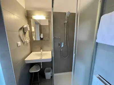 a bathroom with a shower and a sink at Transit Rooms - Your Stopover, Free Parking in Vipiteno