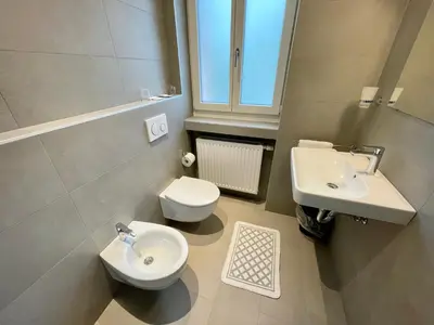 a bathroom with a toilet and a sink at Transit Rooms - Your Stopover, Free Parking in Vipiteno