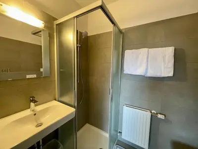 a bathroom with a shower and a sink at Transit Rooms - Your Stopover, Free Parking in Vipiteno
