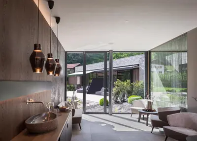 a living room with a sink and a large window at Klein Fein Hotel Anderlahn in Parcines