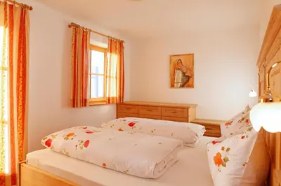 a bedroom with two beds and a window at Apartments Pitschlmann in Fiè