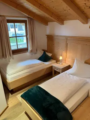 a bedroom with two beds and a window at Apartments Pitschlmann in Fiè