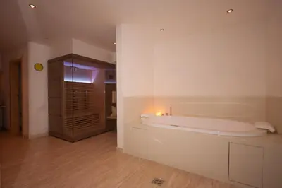 a white bathroom with a tub in a room at Haus Santner in Fiè