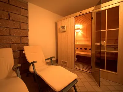 a room with two chairs and a walk in shower at Haus Santner in Fiè