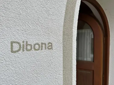 a door to a building with the word dharma on it at Haus Santner in Fiè