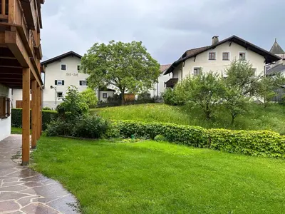 a yard with two white houses and a green lawn at Haus Santner in Fiè