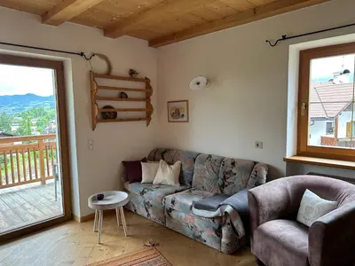 a living room with a couch and a window at Haus Santner in Fiè