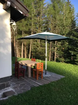 a table and chairs under an umbrella on a patio at il Finferlo in Bellamonte