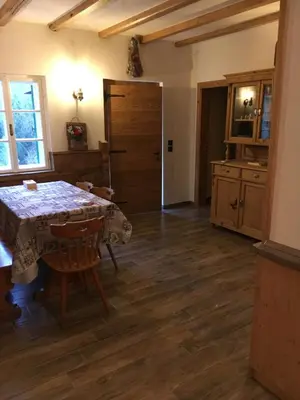 a dining room with a table and a kitchen at il Finferlo in Bellamonte