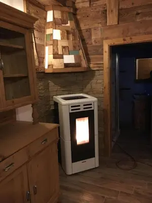 a kitchen with an oven in the middle of a room at il Finferlo in Bellamonte