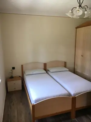 a bedroom with two twin beds and a night stand at il Finferlo in Bellamonte