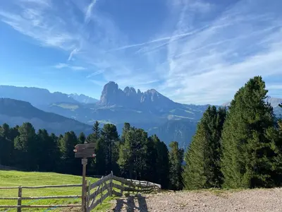 a sign on a hill with a mountain in the background at Apartment Nido in Selva di Val Gardena