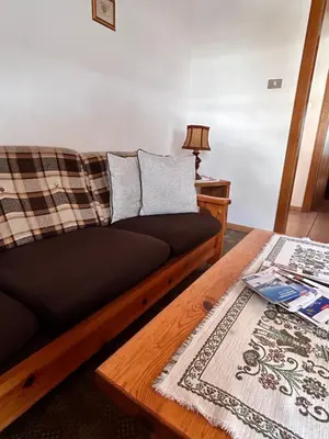 a living room with a couch and a table at Apartment Nido in Selva di Val Gardena