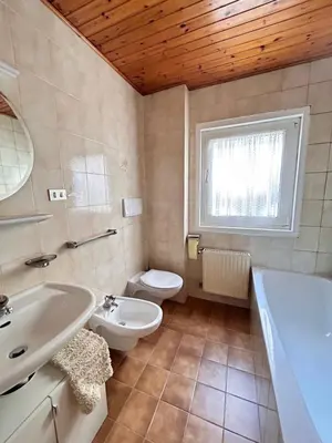 a bathroom with a white sink and a toilet at Apartment Nido in Selva di Val Gardena