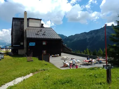 a building with people sitting at a table in front of it at Piccolo Igloo in Falcade