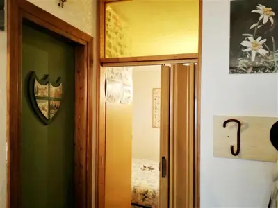 an open door to a room with a bedroom at Piccolo Igloo in Falcade