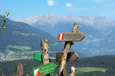 a wooden sign on top of a mountain at Pirchnerhof in San Lorenzo di Sebato