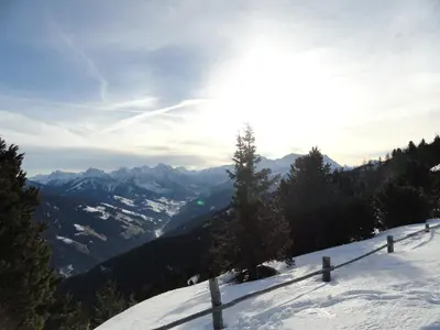 a snow covered mountain with the sun in the background at Pirchnerhof in San Lorenzo di Sebato