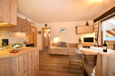 a kitchen and living room with a couch and a table at Pirchnerhof in San Lorenzo di Sebato