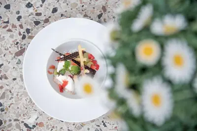 a plate of food on a table next to a christmas tree at Hotel Walter in Schenna