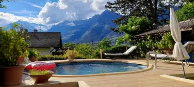 a swimming pool with a view of mountains at HomeSuiteHome in Merano