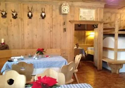a dining room with a table and a bunk bed at Ansitz Goller in Rasun di Sopra