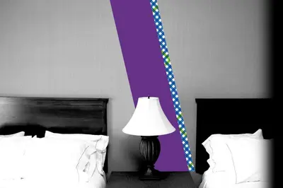 a bedroom with two beds with a lamp and a purple wall at Ansitz Goller in Rasun di Sopra