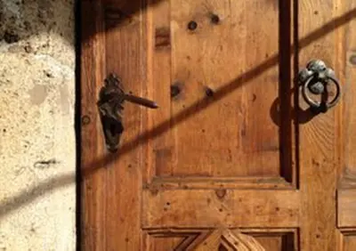 a wooden door with a metal door knocker on it at Ansitz Goller in Rasun di Sopra