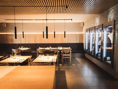 a dining room with tables and chairs and lights at Hotel Panorama in Rablà