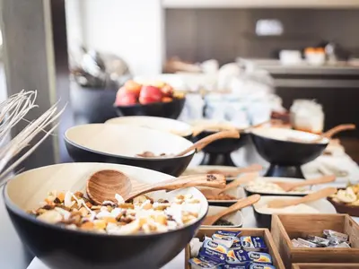 a buffet with bowls of food on a table at Hotel Panorama in Rablà