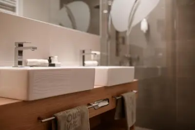 a bathroom with a white sink and a mirror at Sonnen Resort in Naturno