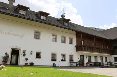 a large white building with a black roof at Lindnerhof Urlaub am Bauernhof in San Lorenzo di Sebato