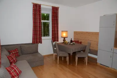 a living room with a table and a couch at Villa Grünewald in Siusi