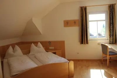 a bedroom with a bed and a window at Villa Grünewald in Siusi
