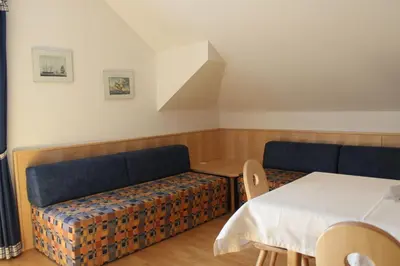 a living room with a couch and a table at Villa Grünewald in Siusi