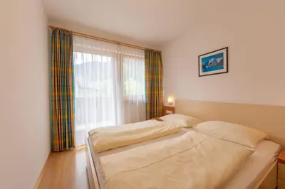 a bedroom with two beds and a window at Residence Trenker Luis in Braies
