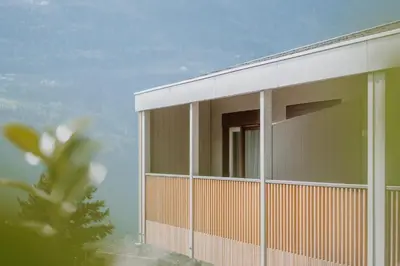 a building with a large window on the side of it at Wanda Apartments in Parcines