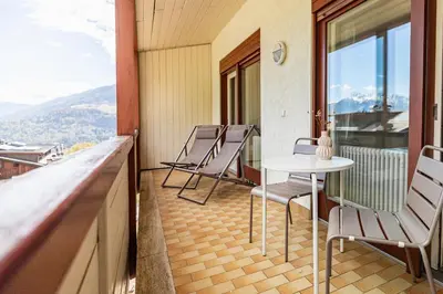 a balcony with chairs and a table with a view at Wanda Apartments in Parcines