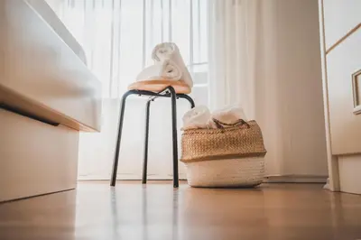 two stools with towels on them sitting in front of a window at Wanda Apartments in Parcines