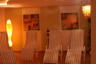 a bedroom with a bed with yellow and orange pillows at Appartements Sigmair in Valdaora