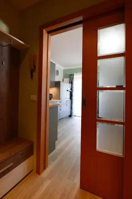 a dining room with tables and chairs and windows at Appartements Sigmair in Valdaora