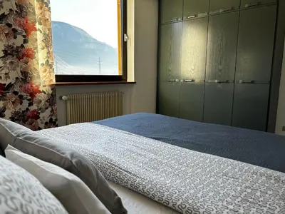 a bedroom with a large bed and a window at St. Vigilhof in Nalles