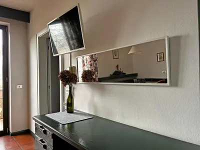 a mirror on a wall with a bottle of wine on a table at St. Vigilhof in Nalles
