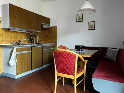 a kitchen with a small table and a kitchen with a counter at St. Vigilhof in Nalles