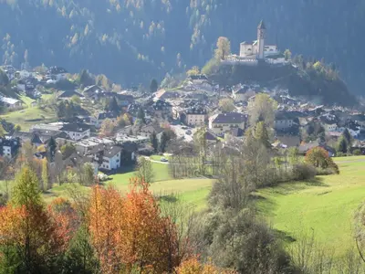 a small town on a hill with a church on top at LA CESURA in Carano