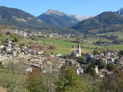 a small town in the middle of a valley with mountains at LA CESURA in Carano