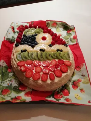 a cake with a face made out of fruit on a plate at LA CESURA in Carano