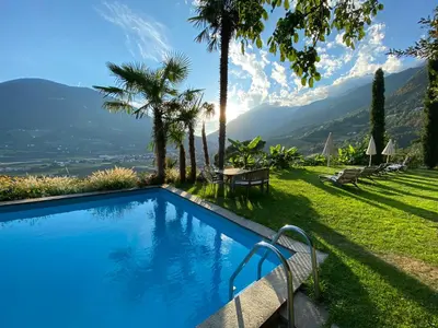 a swimming pool with a view of the mountains at Matailerhof in Tirolo